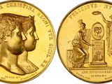 a close up of a gold coin with an image of a woman and a man