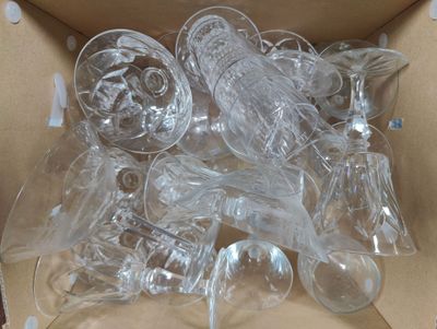 a box full of empty wine glasses in it