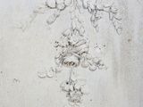 drawing of a cross on a wall with flowers and vines