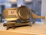 a small metal object that is on a window sill