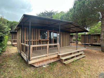 a small wooden cabin with a porch and a covered porch
