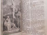 an open book with a picture of a crucif on it