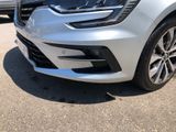 the front end of a silver car parked in a parking lot