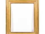 a gold frame on a white wall with a white background
