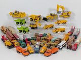 a lot of toy trucks and construction vehicles on the table