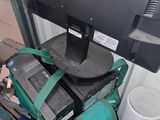 a computer monitor sitting on top of a pile of luggage