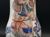a vase with a picture of a woman and a bird on it