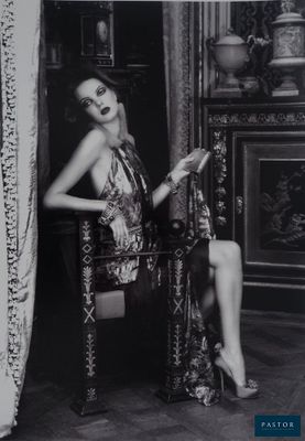 black and white photograph of a woman sitting in a chair in a room
