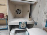 a small room with a clock in the middle of it