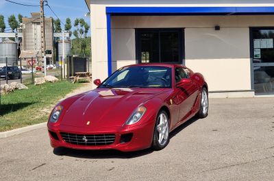 the red sports car is parked in front of a building