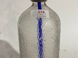 a clear glass bottle with a blue stripe on it