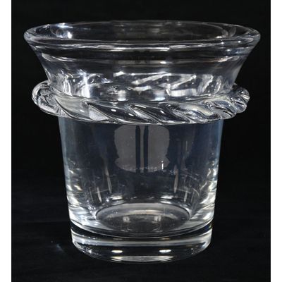 a glass vase with a rope around it on a black surface