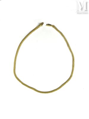 an image of a gold bracelet on a white surface