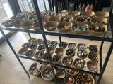 a lot of bowls and bowls that are on a shelf