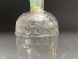 an image of a clear glass bottle sitting on top of a table