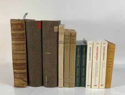 several old books are lined up in a row on a white surface