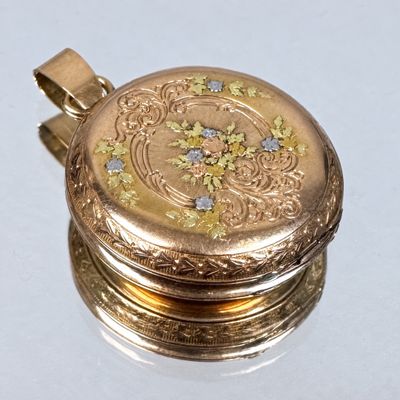 a gold locke with a floral design on it