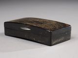 a small black box with a metal handle on a table