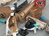 a pile of cardboard boxes and other items on the ground