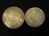 two silver coins, one of which has a crown and the other of which has a crown on it