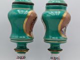 pair of green and gold vases with horses and flowers on them