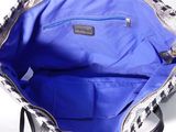 the inside of a blue and white purse with a black handle