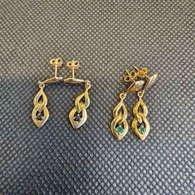 une paire de boucles d'oreilles en or ornées d'émeraudes