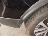a close up of a car ' s front bumper and tire