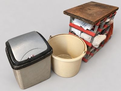 two buckets and a trash can sitting next to each other