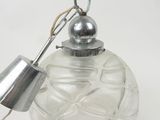 an image of a clear glass ornament with a metal lamp on it