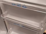 a refrigerator with its door open and a freezer door open