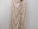 a gold sequinned pants hanging on a hanger