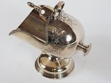 a silver teapot with a handle on a stand