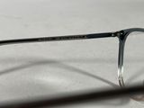 a pair of glasses sitting on a table next to a pair of glasses