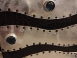 a close up of a metal plate with rivets