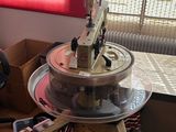 a table with a machine on top of it in front of a window
