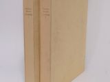 two books that are sitting on a white surface
