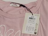 a pink t - shirt with a white design on it