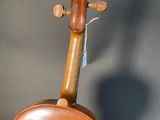 an old violin sitting on top of a wooden table next to a wall