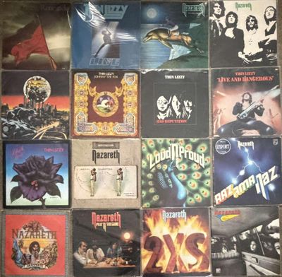 many different album covers on the wall of a room