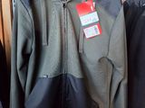 two jackets hanging on a rack in a store