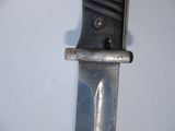 a close up of a knife on a white surface