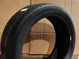an image of a tire sitting on the floor in front of a cardboard box