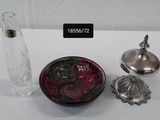 a small glass vase and a small glass container on a table