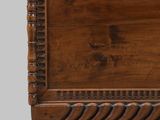 an old wooden chest sitting on top of a wooden table