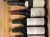 six bottles of wine in a wooden box