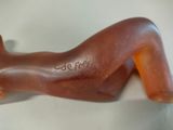 a chocolate sculpture of a woman laying down on a table
