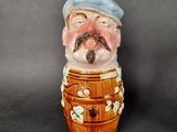 a ceramic figurine of a man with a mustache and a hat
