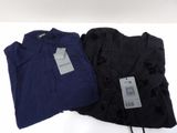 two black and blue shirts with tags on them sitting on a white surface