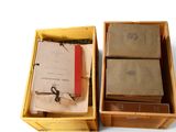 two boxes with books inside of them on a white surface